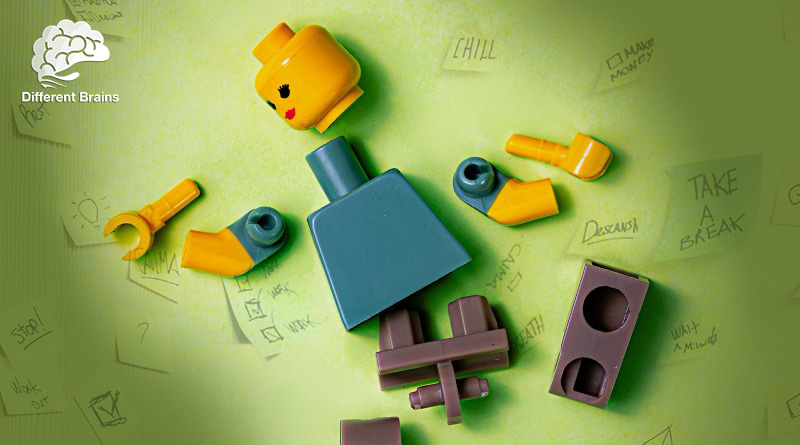 A lego person lays in pieces surrounded by post it notes with tasks listed on them.