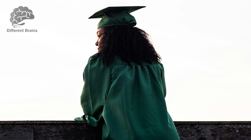 a woman in graduation gown and cap looks into the distance