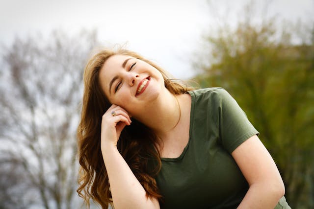 A woman in a green shirt smiling