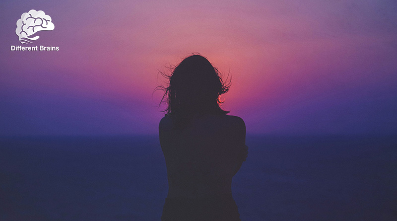 A person is shown standing in silhouette in front of a sunset.