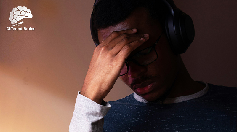 A man touches his hand against his forehead