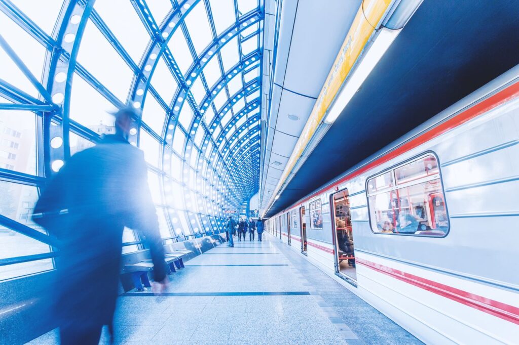 Blurred commuters moving through a train station
