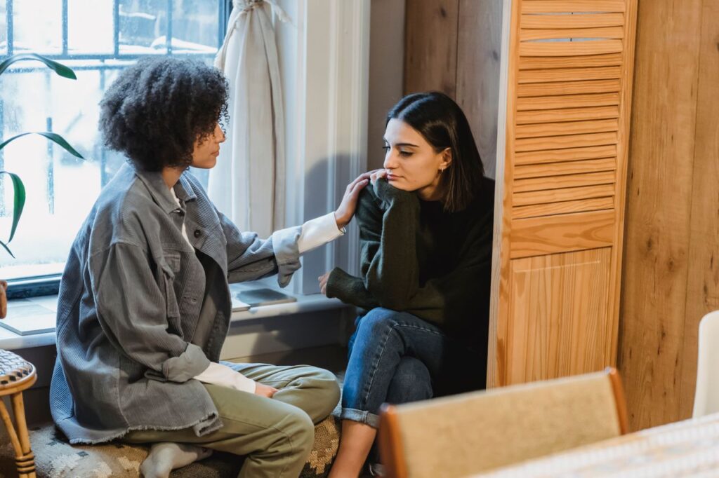 Woman calmly supporting a distressed friend