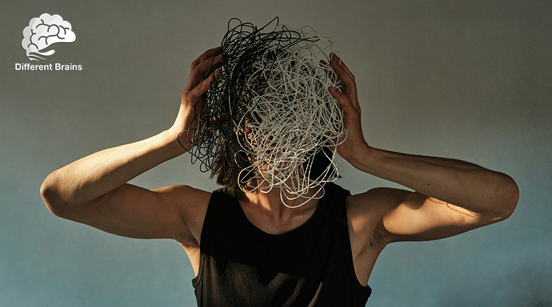 A woman holds her hands to her head, while her face is obscured by a jumbled mass.